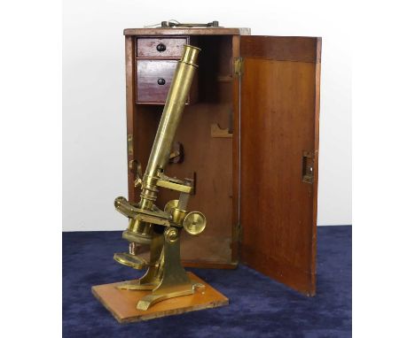 A late Victorian lacquered brass monocular microscope by Baker of High Holborn, London, housed in a fitted mahogany case with