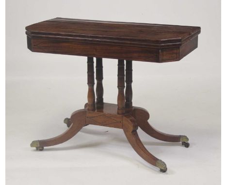 A Regency mahogany pedestal card table, having a fold-over top with canted corners, swivel action opening to reveal a baize l