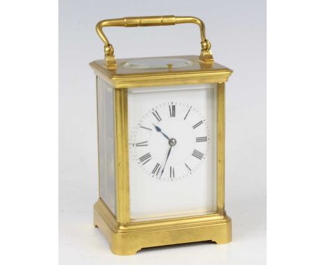 A late 19th century French lacquered brass carriage clock by Henri Jacot of Paris, having an unsigned white enamel Roman dial