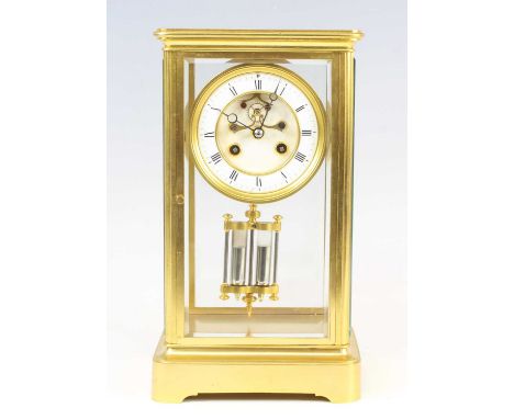 A late 19th century French lacquered brass four-glass mantel clock, having an unsigned white enamel Roman dial with visible e