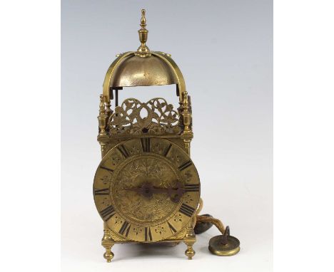 A circa 1700 brass lantern clock, the leaf and flower engraved dial below pierced dolphin frets and strapwork bell and finial