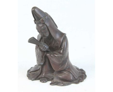 A Chinese bronze scroll weight, cast as a robed figure with fan in right hand, late Ming-Qing Dynasty style, h.7cm.