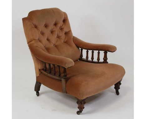 A late Victorian walnut framed library armchair in the manner of Howard &amp; Sons, the whole re-upholstered in a beige butto