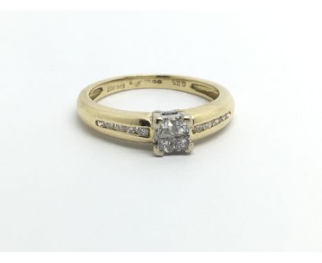 An 18ct gold diamond ring set with four diamonds and further small diamonds to the shoulders, approx.25ct, approx 3.4g and ap