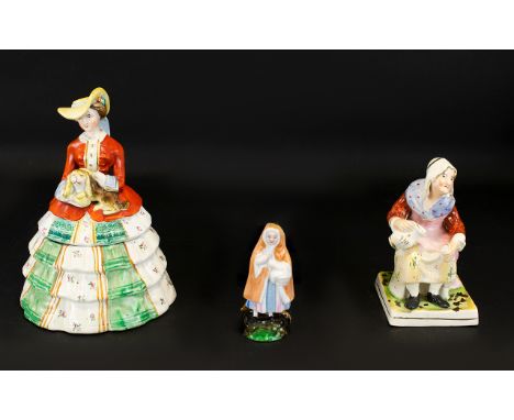 A Staffordshire Figure In The Form Of A Seated Peasant Woman Together with a German nursery rhyme figure of Little Red Riding