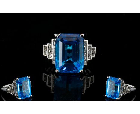 Large Swiss Blue Topaz and White Topaz Statement Ring, a 15ct octagon cut Swiss Blue topaz solitaire of brilliant colour and 