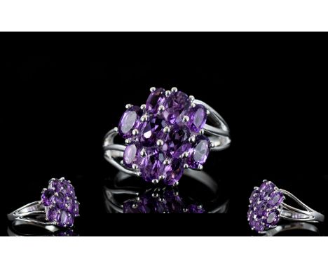 Amethyst Diagonally Set Cluster Ring, 10 oval cut amethysts, totalling 3cts, set diagonally on a silver ring with triple row 