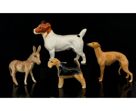 A Collection Of Beswick Ceramic Figures Four in total to include model no.962 Airdale Terrier 'Cast Iron Monarch' black and t