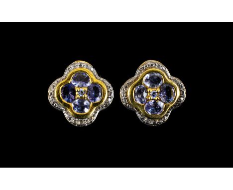 Tanzanite Pair of Quatrefoil Stud Earrings, the earrings having four round cut tanzanites of good colour, set around a smalle