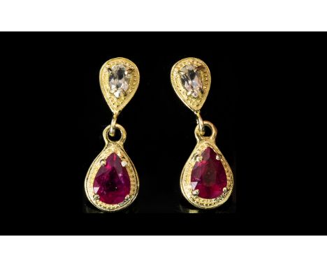 Ruby and White Topaz Drop Earrings, pear cut ruby solitaires suspended below inverted pear cut white topaz framed in gold ver