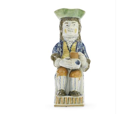 A rare Prattware 'Thin Boy' Toby Jug, circa 1790-1800Seated in a green upright chair with his feet resting on a small step, g