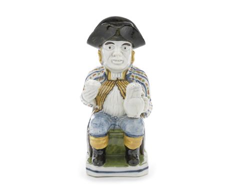 A very rare Prattware 'Postillion' Toby Jug and cover, circa 1800-10Modelled seated on a chair with a high scrolled back, the