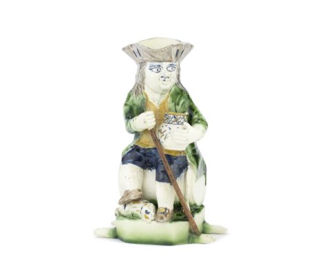 A very rare creamware 'Admiral Lord Howe' Toby jug, circa 1785Modelled seated on a barrel, a recumbent spaniel at his feet an