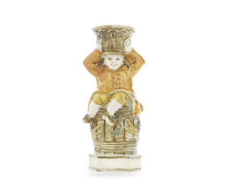 A rare Prattware 'Boy On A Barrel' Toby Jug, circa 1800Modelled as a boy perched on a barrel, the basket balanced on his head