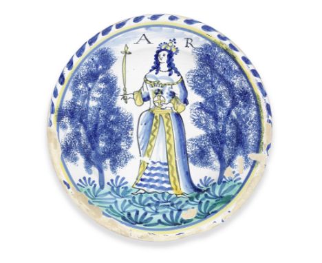 A London Delftware Queen Anne charger, circa 1702-14Possibly Norfolk House, painted with a full length portrait of the Queen,