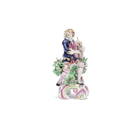A Bow figure of a bagpiper, circa 1770-75Seated on a stump flanked by flowering bocage, wearing a puce hat, blue coat and flo