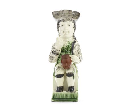 A Wood Family 'Thin Man' Toby Jug, circa 1785-90Seated in an upright chair picked out in green with his feet resting on a ste