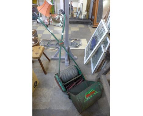 A vintage green metal Webb lawnmower 