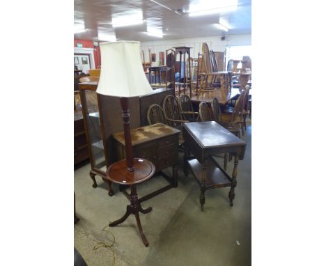 An oak trolley, a carved oak credence cupboard and a mahogany standard lamp 