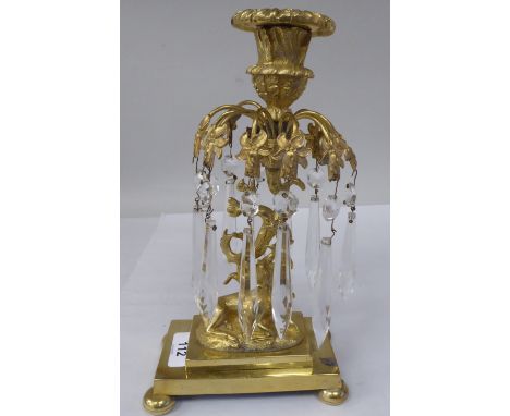 A 19thC gilt metal candlestick with a detachable sconce, in a vase shape socket, over a series of two part cut crystal pendan