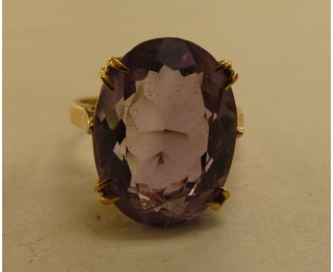 A 9ct gold ring, set with a light purple coloured stone 