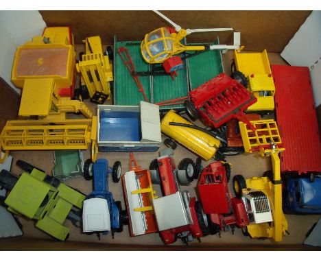 Box containing a selection of various Britians agricultural vehicles, flat bed trailers, combined harvesters, fork trucks etc
