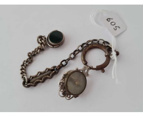 A white metal chain with fobs and compass