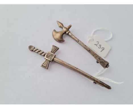 Two silver brooches in the forms of a axe and sword 