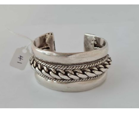 Antique North African very heavy silver bangle with centre twist decoration and relevant hallmarks to each end, 35 mm wide. 1
