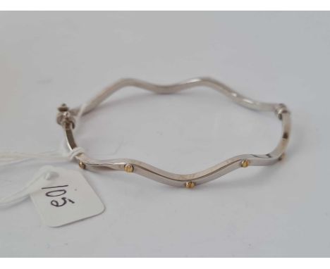 A white gold designer wave hinged bangle with yellow gold bolt 9ct 