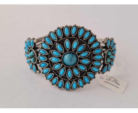 A white metal turquoise torque bangle 