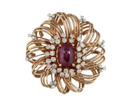 A ruby and diamond cluster brooch, the central oblong cabochon ruby claw set within a surround of brilliant cut diamonds, in 