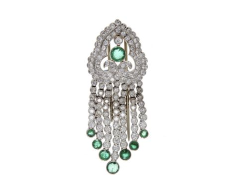 An emerald and diamond clip brooch, the Paisley type scroll top centrally set with a circular cut emerald in a brilliant cut 