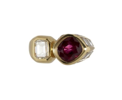 A ruby and diamond cross over ring, the cushion shaped mixed cut ruby rub over set next to a cut cornered step cut diamond, s