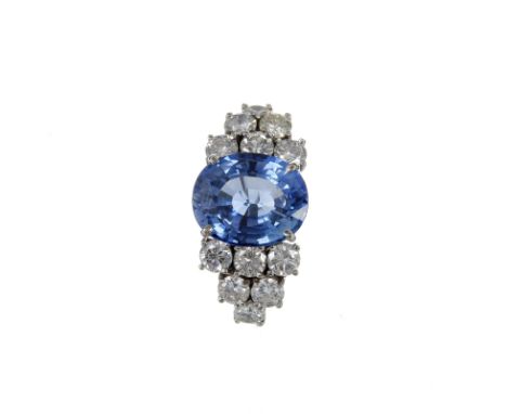 A sapphire and diamond ring, the central oval mixed cut sapphire, stated to weigh 6.50 carats, claw set above six stone brill