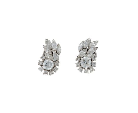 A pair of diamond earrings, the central brilliant cut diamonds claw set above a surround of smaller brilliant cut diamonds, b