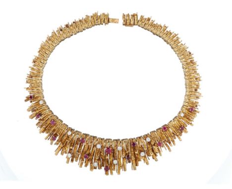 A French ruby and diamond collar by Chaumet, the graduated textured gold coloured fronds suspended from foxtail chains behind
