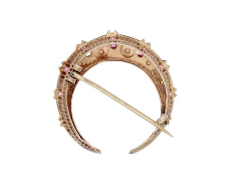 A late 19th century half pearl and ruby crescent brooch, set with graduated half pearls and circular cut rubies, unmarked, 2.