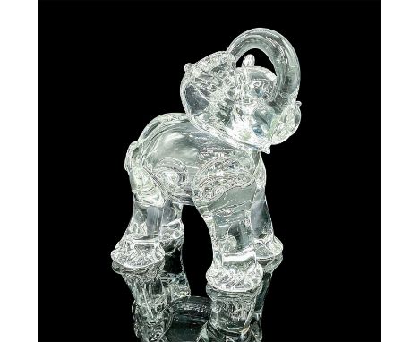 A translucent figure of an elephant raising its trunk over its head. Dimensions: 6.25"L x 4.75"W x 7.5"HCondition: Age relate