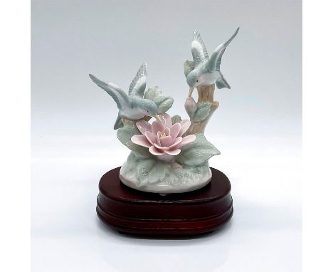 Vintage figurine of two hummingbirds over a pink flower. Includes a wooden musical base, melody unknown. Royal Carlton backst