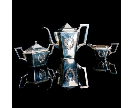 Victorian style coffee pot, creamer, and lidded sugar bowl decorated with incised scrolling shield and lettering. Coffee pot 