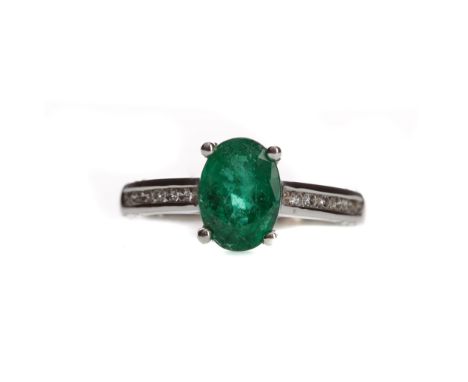 EMERALD AND DIAMOND RING, set with an oval emerald of approximately 1.70 carats, on diamond shoulders, in eighteen carat whit