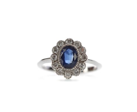 CERTIFICATED SAPPHIRE AND DIAMOND RING, set with an oval sapphire of approximately 0.92 carats, within a halo of round brilli