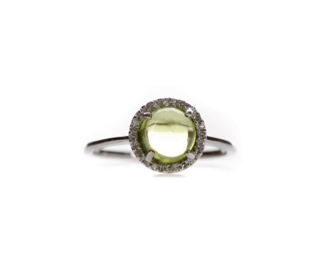 PERIDOT AND DIAMOND RING, set with a cabochon peridot within a halo of round brilliant cut diamonds totalling approximately 0