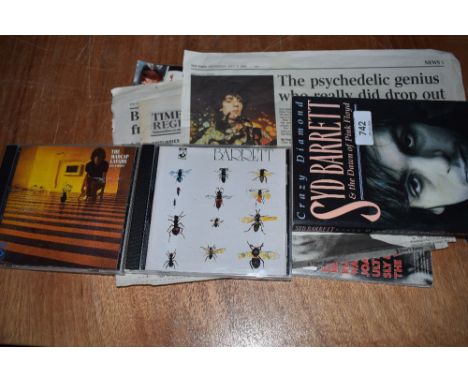 A Syd Barrett book , two compact discs and some rare newspaper cuttings and a magazine with a Syd article - Pink Floyd intere