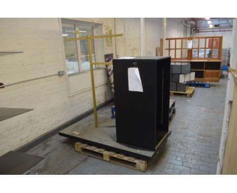 A shop display unit with tubular square section rear bracket and open bookcase front, overall mounted on a rectangular plinth