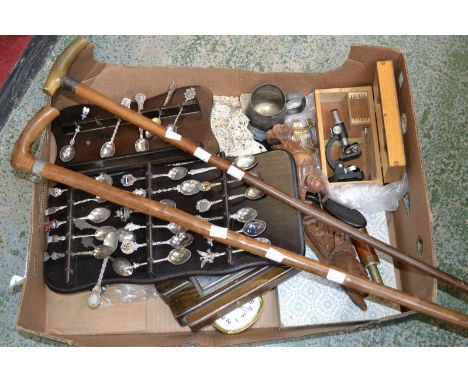 A wall barometer; a Victorian EP christening mug; a carved hardwood figure; a tea spoon collection; lace doilies; a silver mo