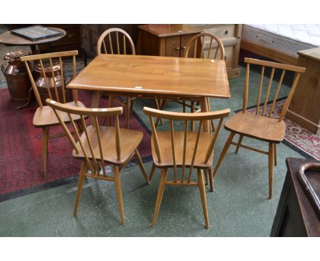 An Ercol elm and beech dining suite comprising rectangular  breakfast table with rack, four Windsor bow top chairs, two Winds