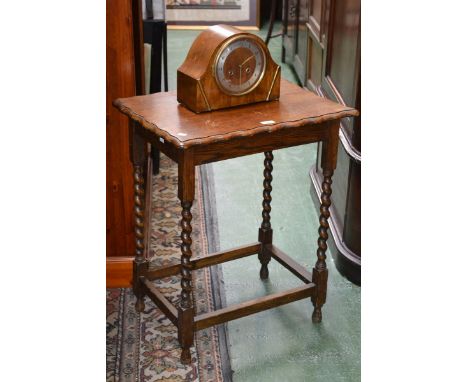 A 1930's oak mantle clock, with key; barley twist table (2)