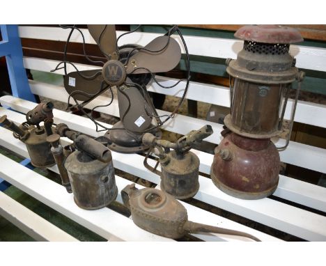 A Westinghouse electric fan; two mid 20th century blow lamps; a paraffin lamp; a pick axe; etc. (7)